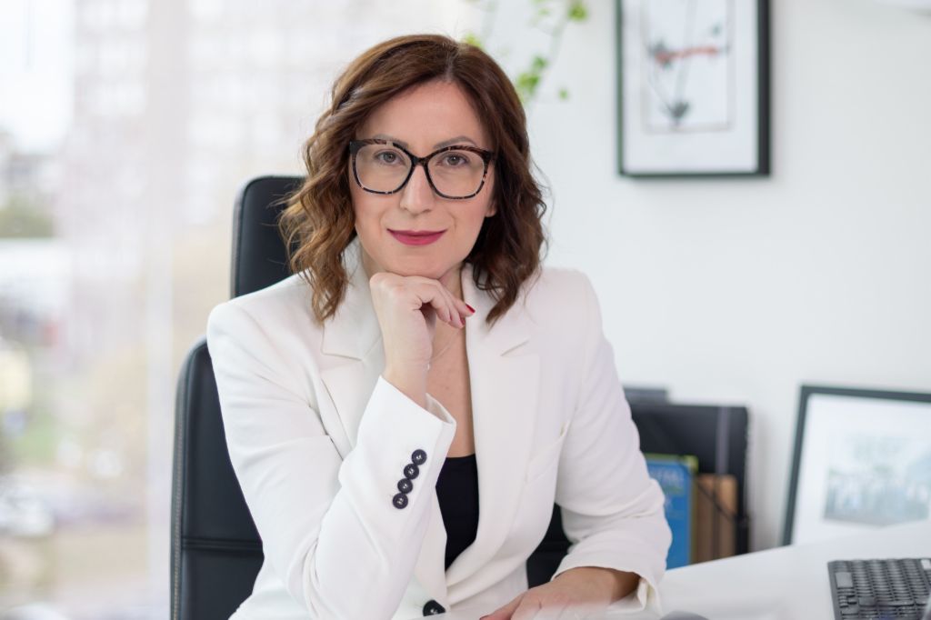 Jelena Jovic sitting at her desk facing the camera